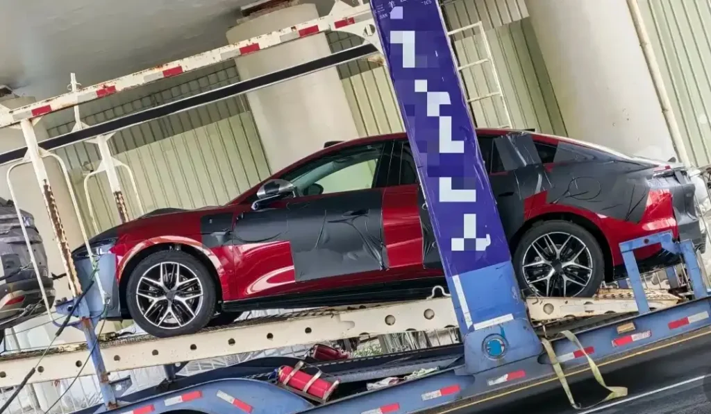 All-new BYD Han red sedan prototype on car transporter, camouflage wrapped with roof lidar