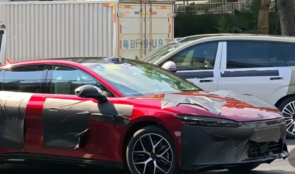 All-new BYD Han red sedan side-front spy shot with protective wrapping, roof lidar